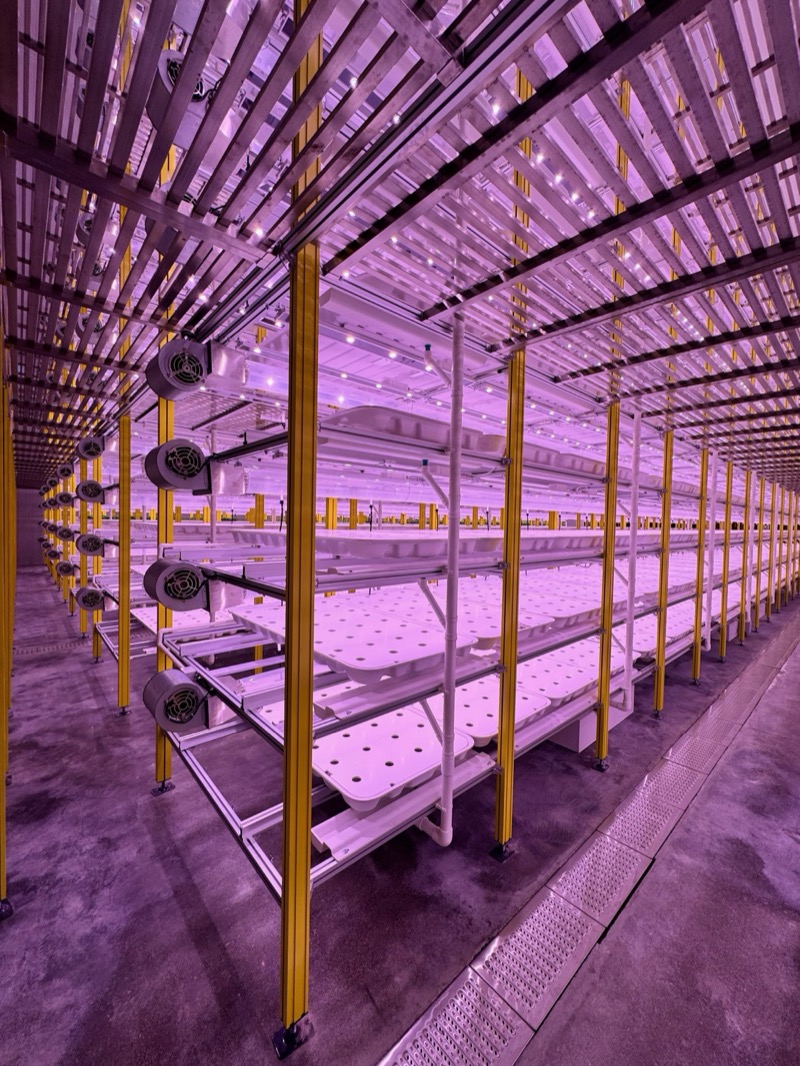 Empty HYVE rack aisle showing ventilation fans and LED lighting infrastructure